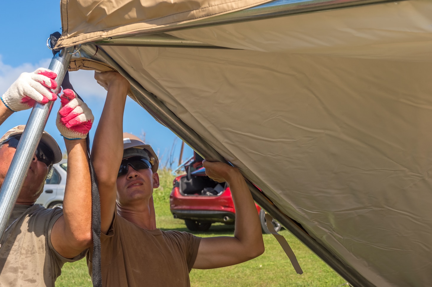 TINIAN, Commonwealth of the Northern Marianas Islands (Nov. 7, 2018) Engineering Aide Constructionman Cameron Tanner, assigned to Naval Mobile Construction Battalion 1, and a Tinian official erect a FEMA-provided tent for a Tinian family whose home was destroyed by Super Typhoon Yutu. Service members from Joint Region Marianas and Indo-Pacific Command are providing Department of Defense support to the Commonwealth of the Northern Mariana Islands' civil and local officials as part of the FEMA-supported Super Typhoon Yutu recovery efforts.