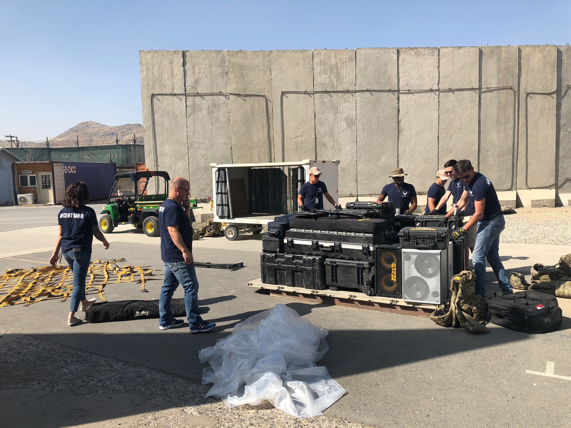Members of the U.S. Air Forces Central Command Band stack their music equipment on a pallet at Kabul, Afghanistan Sept. 17, 2018. The band has to build to the strict requirements of Logistics, Readiness and Services standards, preparing their gear for transit on Air Force aircraft. In addition to performing, band members are responsible to load and transport their equipment. (U.S. Air Force photo by Capt. Dustin Doyle)