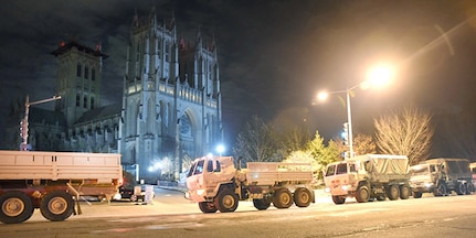 District of Columbia National Guard Soldiers create a security barrier using light medium tactical vehicles in front of the Washington National Cathedral prior to the state funeral for 41st U.S. President George H.W. Bush, Dec. 5, 2018.