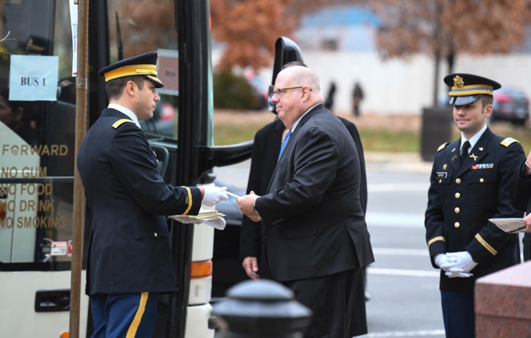 Maj. Joshua Behsudi, Mobilization Augmentation Command branch chief, hands Maryland Gov. Larry Hogan an invitation to the state funeral for 41st U.S. President George H.W. Bush prior to departing to the Washington National Cathedral Dec. 5, 2018.