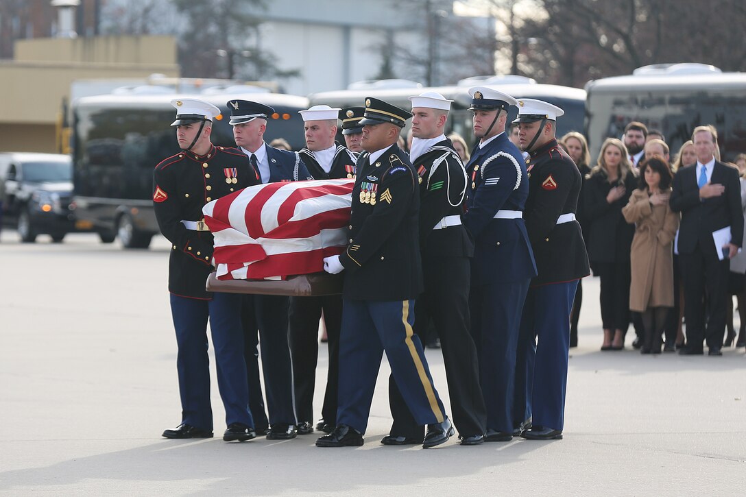 U.S. service members with the Ceremonial Honor Guard carry the casket to Air Force One, Andrews Air Base, Maryland, Dec. 05, 2018. Nearly 4,000 military and civilian personnel from across all branches of the U.S. armed forces, including Reserve and National Guard components, provided ceremonial support during the state funeral of George H.W. Bush, the 41st President of the United States.