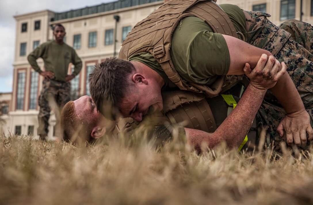 Sgt. David Kelley, the substance abuse control officer with Headquarters Battalion, Marine Forces Reserve, takes down his opponent in the quarter finals of the MFR King of the Ring tournament at Marine Corps Support Facility New Orleans, Nov. 30, 2018. The MFR King of the Ring tournament is a competition that involves knife fighting, grappling and baton fighting to determine who is the most well-rounded competitor. (U.S. Marine Corps photo by Sgt. Dante J. Fries)