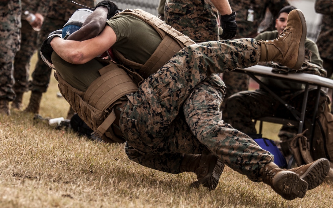 Marines with Marine Corps Support Facility New Orleans get into a tie up during the knife fighting portion of the Marine Forces Reserve King of the Ring tournament, resulting in a tackle with ground hand-to-hand combat during the final seconds of their competition, Nov. 30, 2018. Marine Corps mixed martial arts prepares Marines to quickly take appropriate action whether it be offensively or defensively at any given moment. The MFR King of the Ring tournament is a competition that involves knife fighting, grappling and baton fighting. (U.S. Marine Corps photo by Sgt. Dante J. Fries)
