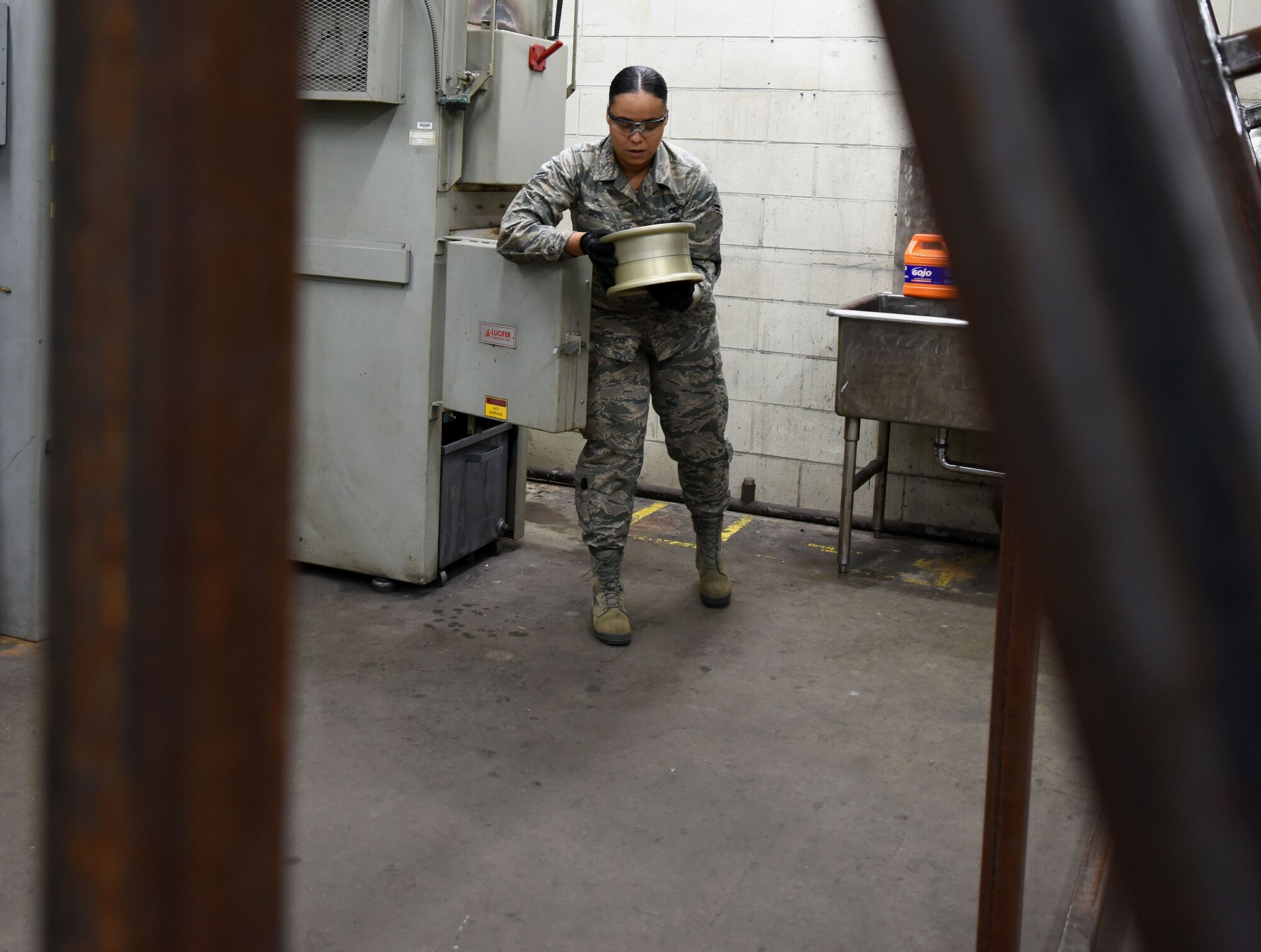 U.S. Air Force Airman 1st Class Sondra Saul, 20th Equipment Maintenance Squadron aircraft metals technician apprentice, retrieves an F-16 Fighting Falcon wheel bearing, from an oven in the metal shop, at Shaw Air Force Base S.C., Nov. 30, 2018.