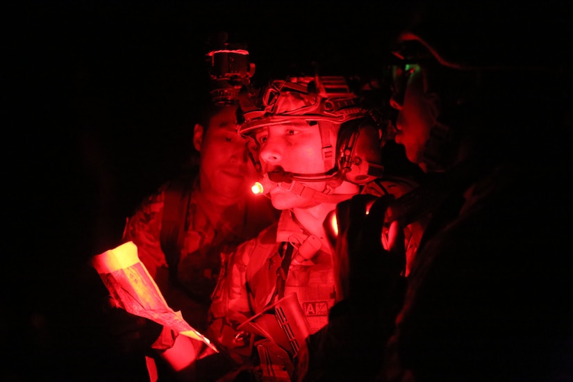 Spc. Austin Boucher and teammates assess a map.