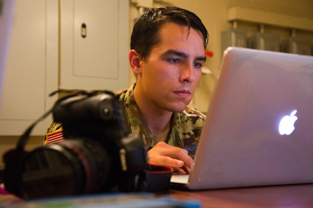 Army Spc. Austin Boucher looks at a computer.