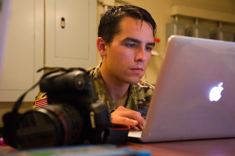 Army Spc. Austin Boucher looks at a computer.