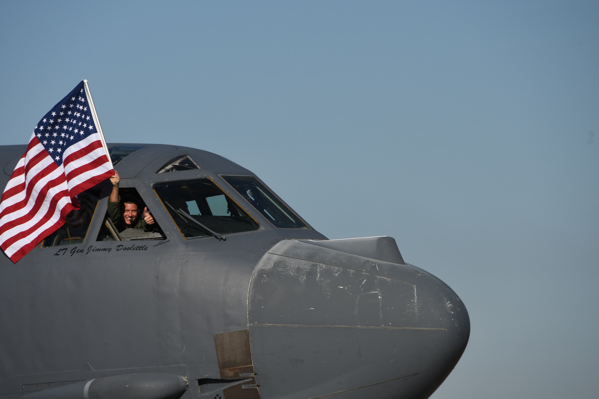 A Reserve Citizen Airman waves a U.S. flag from a B-52 Stratofortress prior to a sortie at Barksdale Air Force Base, Louisiana, March 3, 2017. (U.S. Air Force photo by Master Sgt. Ted Daigle)