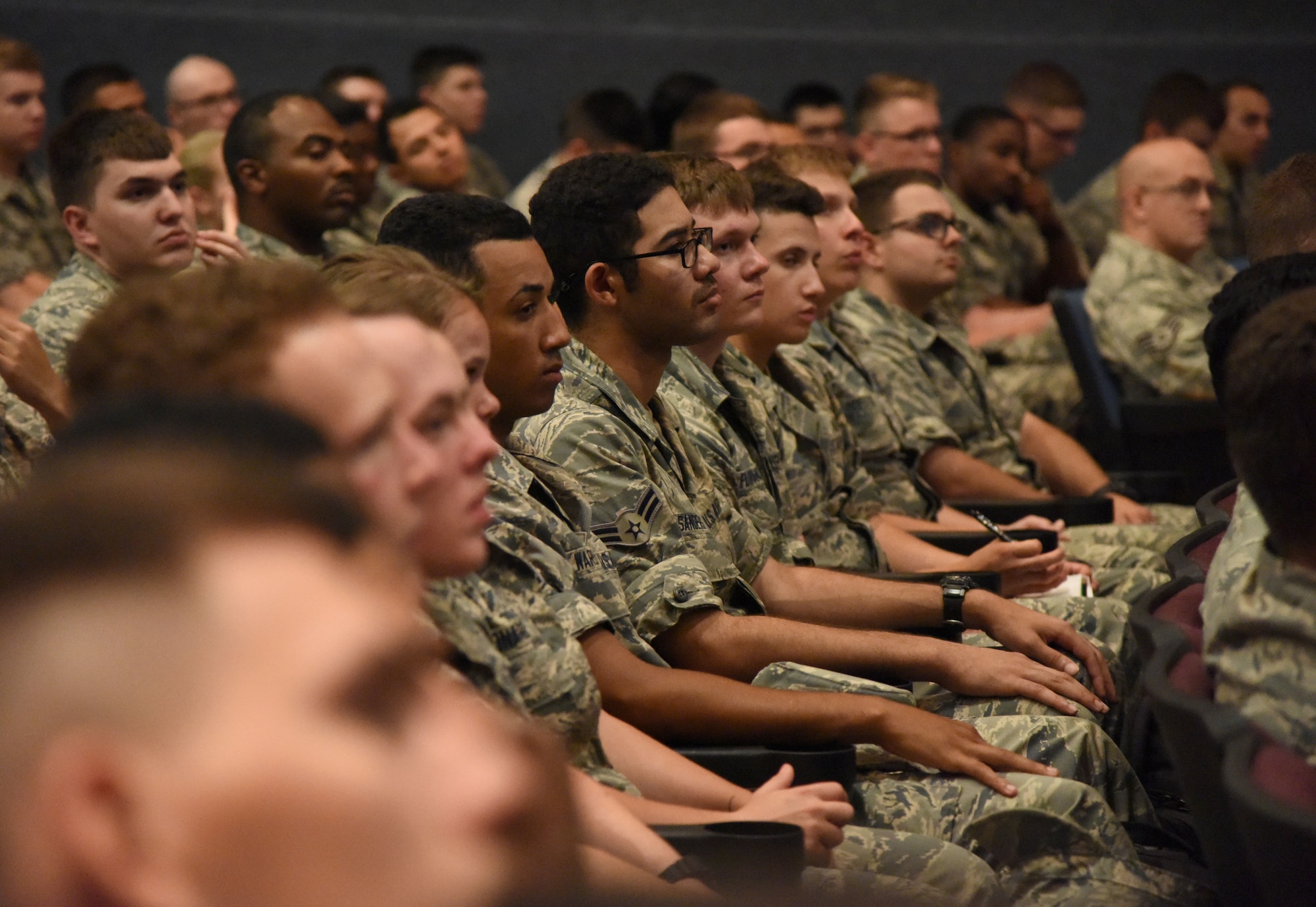 Airmen attend a Security Plus Town Hall meeting at the Welch Theater at Keesler Air Force Base, Mississippi, June 11, 2018. The meeting, hosted by Lt. Col. Daniel Schmitt, 336th Training Squadron commander, was held to address any concerns by 81st Training Group personnel about the transitioning process and resource materials provided for the new course. (U.S. Air Force photo by Kemberly Groue)