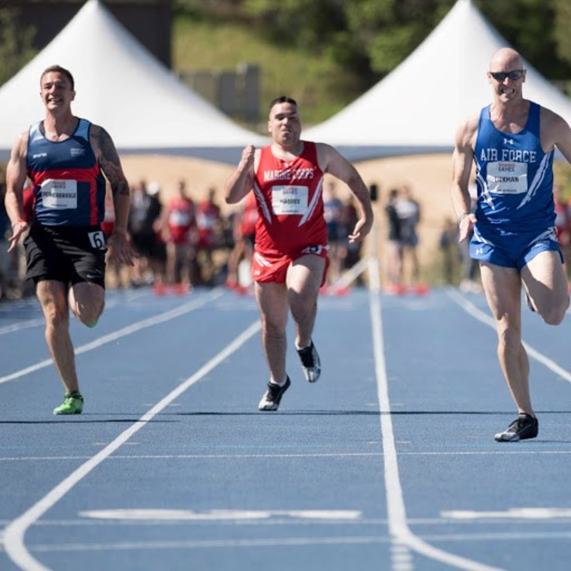 AFOSI Special Agent Bill Lickman, right, of Detachment 223, Tyndall Air Force Base, Fla., staves off competition from sister services during a Department of Defense Warrior Games track event at the United States Air Force Academy, Colo., in June 2018. (Photo by AFW2)
