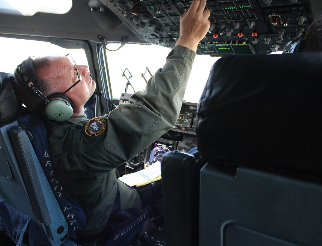 Lt. Col. Bill Barton, 89th Airlift Squadron C-17 pilot, goes through his check list in preparation for takeoff.