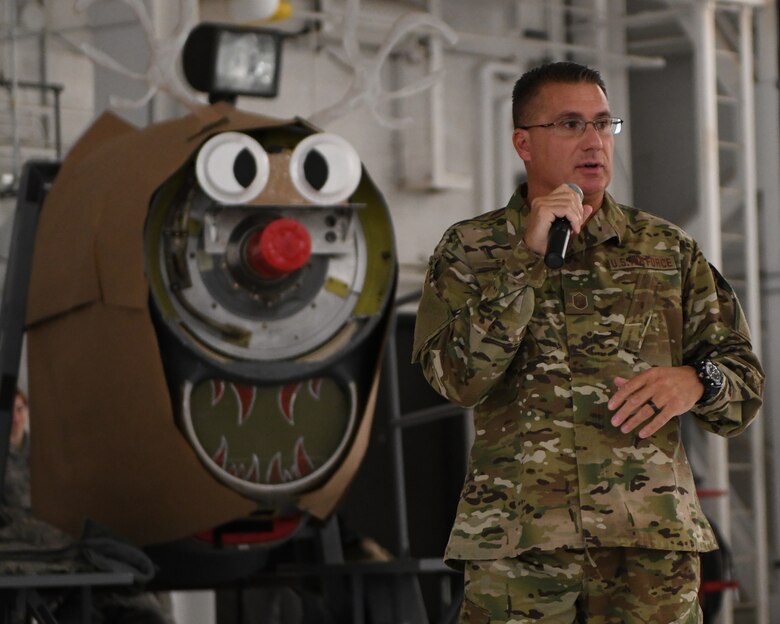 Master Sgt. John Falfas, 910th Airlift Wing career assistance advisor, speaks to 910th Airlift Wing members during the holiday commander’s call in Hangar 305 at Youngstown Air Reserve Station, Dec. 1, 2018.