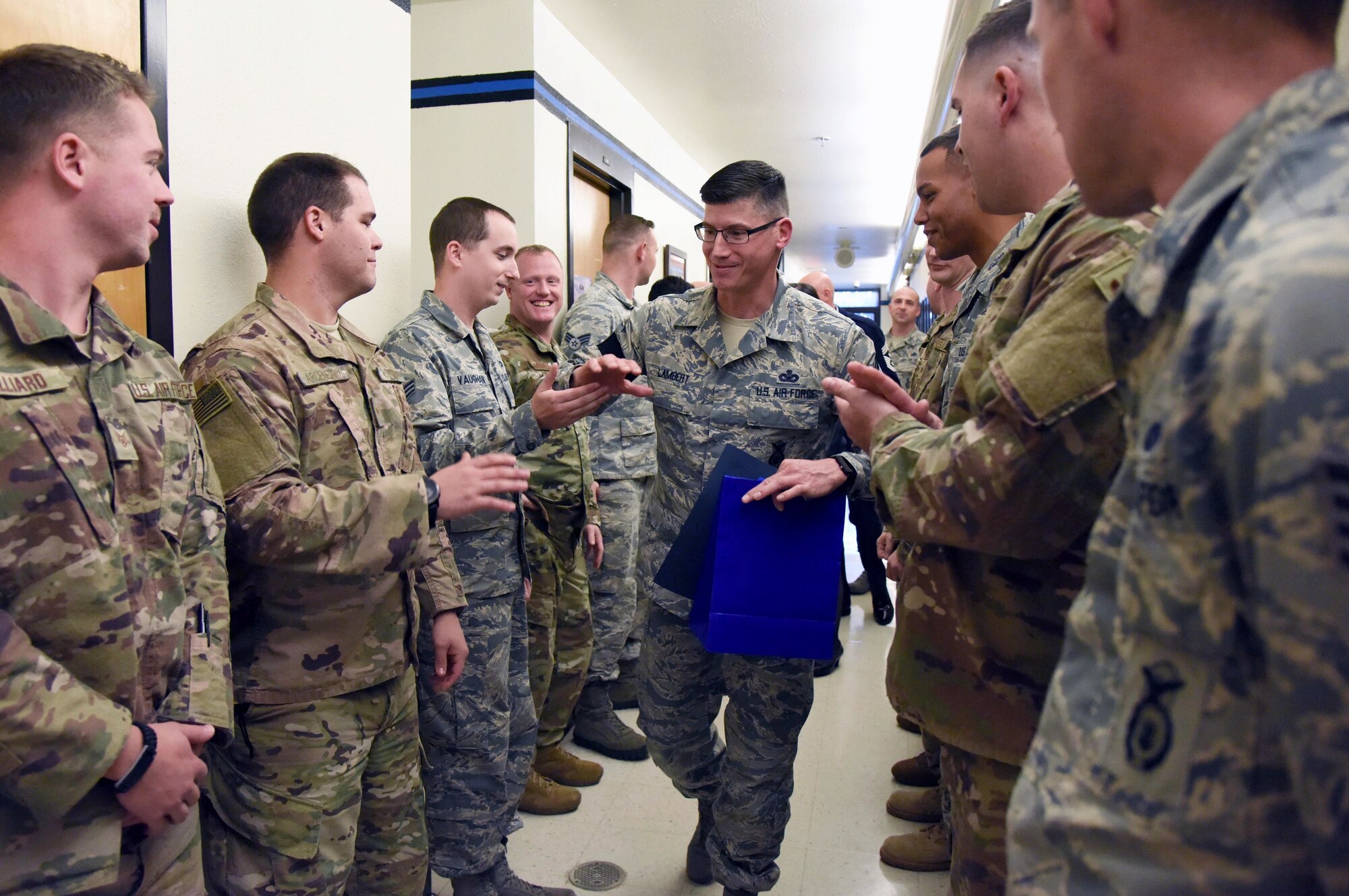 U.S. Air Force Senior Master Sgt. Kevin Lambert, 81st Security Forces Squadron operations superintendent, is congratulated upon the notification of his promotion to the rank of chief master sergeant at Keesler Air Force Base, Mississippi, Dec. 4, 2018. Five senior master sgts. were notified and congratulated for their promotion by the base's leadership and chiefs. (U.S. Air Force photo by Kemberly Groue)