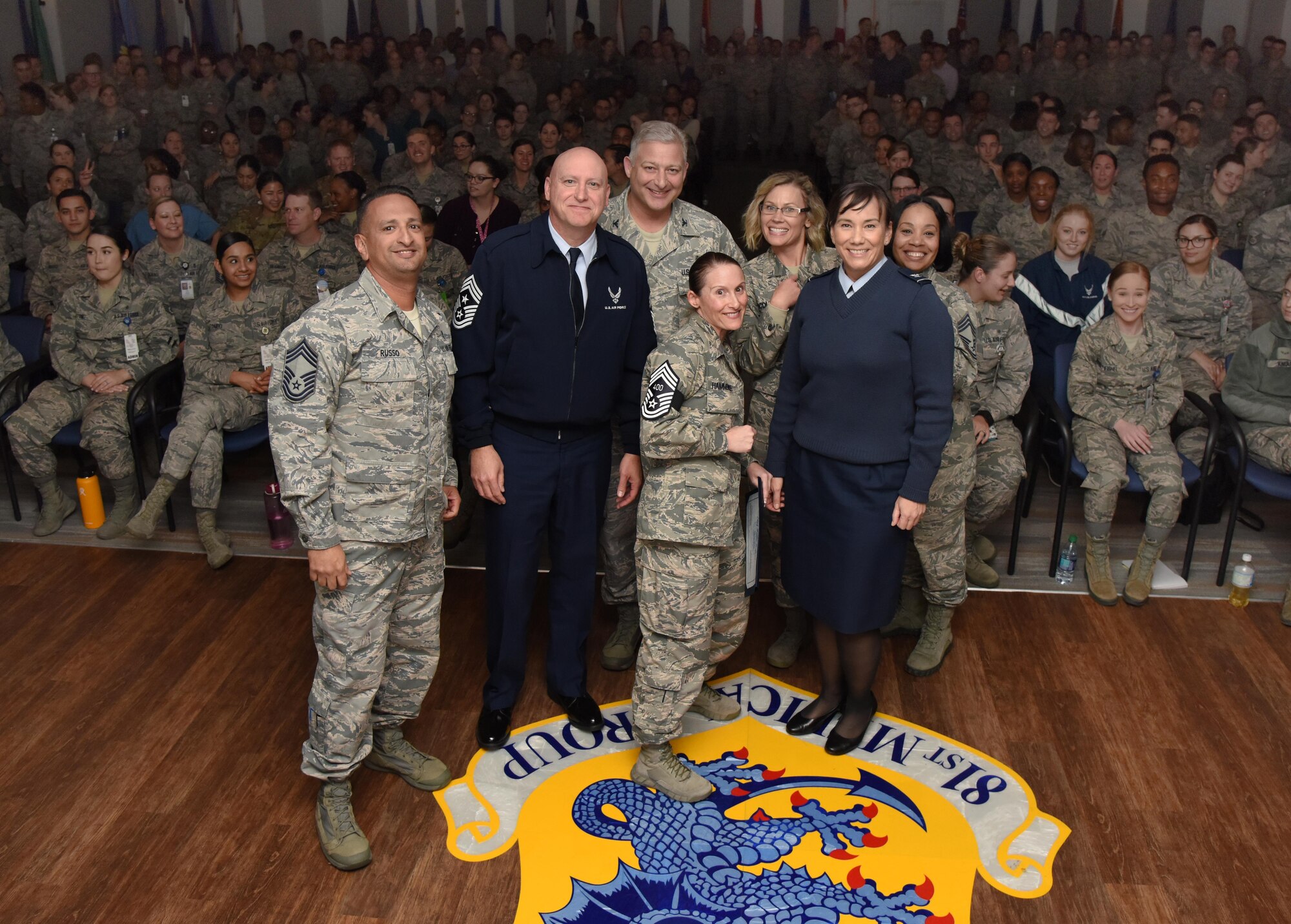U.S. Air Force Senior Master Sgt. Katie Hammonds, 81st Medical Support Squadron medical logistics flight chief, poses for a group photo with base leadership upon the notification of her promotion to the rank of chief master sergeant at Keesler Air Force Base, Mississippi, Dec. 4, 2018. Five senior master sgts. were notified and congratulated for their promotion by the base's leadership and chiefs. (U.S. Air Force photo by Kemberly Groue)