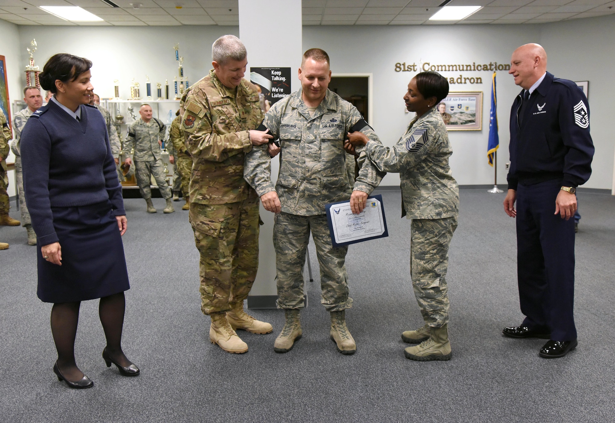 U.S. Air Force Senior Master Sgt. Michael Sterling, 81st Communications Squadron superintendent, receives his new stripes by Keesler leadership upon the notification of his promotion to the rank of chief master sergeant at Keesler Air Force Base, Mississippi, Dec. 4, 2018. Five senior master sgts. were notified and congratulated for their promotion by the base's leadership and chiefs. (U.S. Air Force photo by Kemberly Groue)