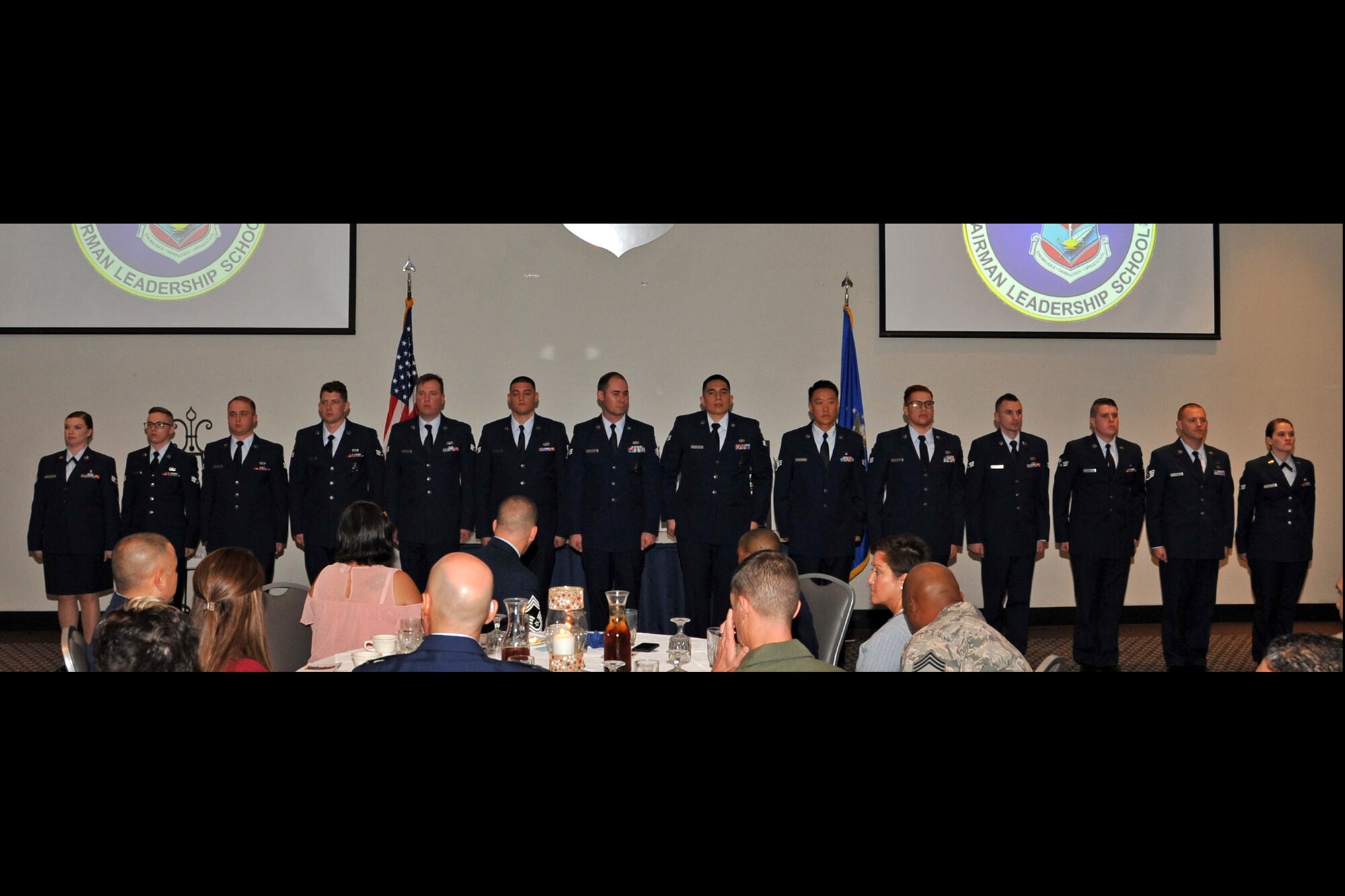 Airman Leadership School Class 19-A stands before attendees of their graduation ceremony, before singing the “Air Force Song,” at the Event Center on Goodfellow Air Force Base, Texas, Dec. 6, 2018. ALS is a six-week course designed to prepare senior airmen to assume supervisory duties by offering instruction in leadership, followership, written and oral communication skills, and the profession of arms.  (U.S. Air Force photo by Airman 1st Class Zachary Chapman/Released)