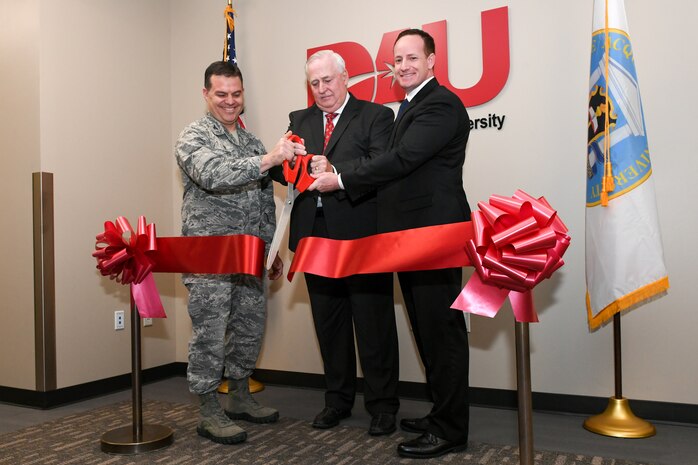 Defense Acquisition University held a grand opening ceremony Dec. 4, 2018, at its new location in the Falcon Hill complex at Hill Air Force Base, Utah. Cutting the ribbon are Col. Gabriel Lopez, 75th Mission Support Group commander, Kevin Carman, DAU West Region dean, and Jude Gronenthal, DAU West Region director. The new location will nearly double student capacity to 126 with four classrooms from its previous location. DAU is a corporate university of the Department of Defense offering acquisition, technology, and logistics training to military and federal civilians. (U.S. Air Force photo by Cynthia Griggs)