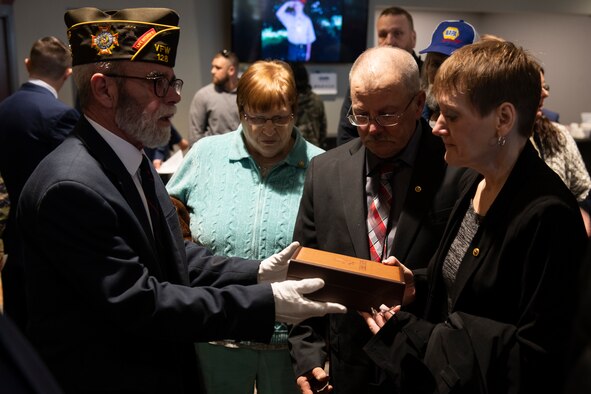 Dawna Duez, mother of U.S. Air Force Staff Sgt. Dylan Elchin, a Special Tactics combat controller with the 26th Special Tactics Squadron, is presented a gift by a Veterans of Foreign Wars member during a memorial service in Moon Township, Pennsylvania, Dec. 6, 2018.