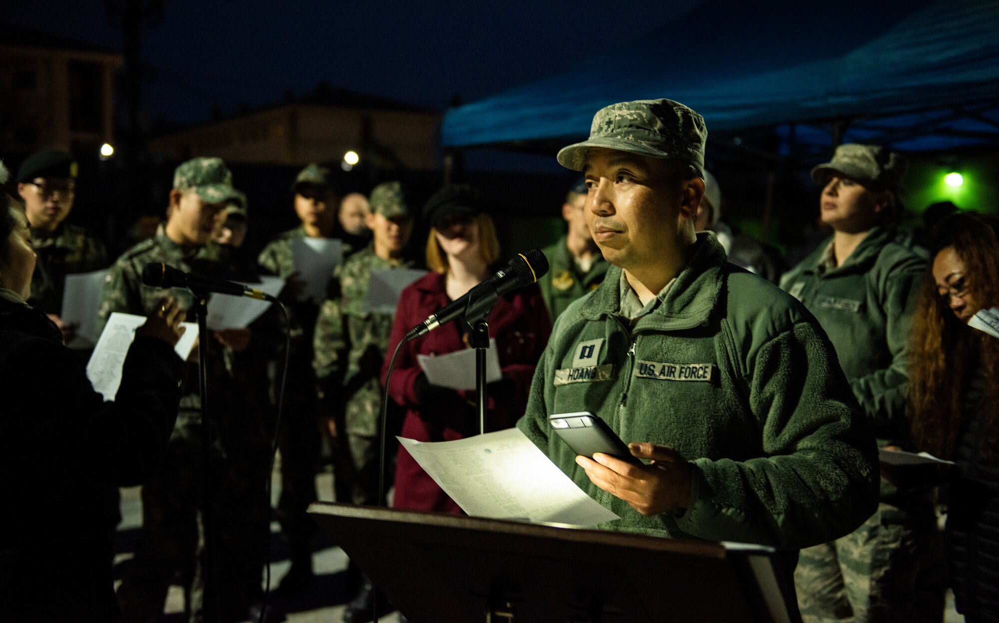 U.S. Air Force Capt. Joseph Hoang, an 8th Fighter Wing chaplain, sings Christmas carols at Kunsan Air Base, Republic of Korea, Nov. 29, 2018. The 8th FW chapel, held a base-wide event for the Wolf Pack and Republic of Korea Air Force’s 38th Fighter Group to come out and be a part of the tree lighting ceremony. (U.S. Air Force photo by Senior Airman Stefan Alvarez)