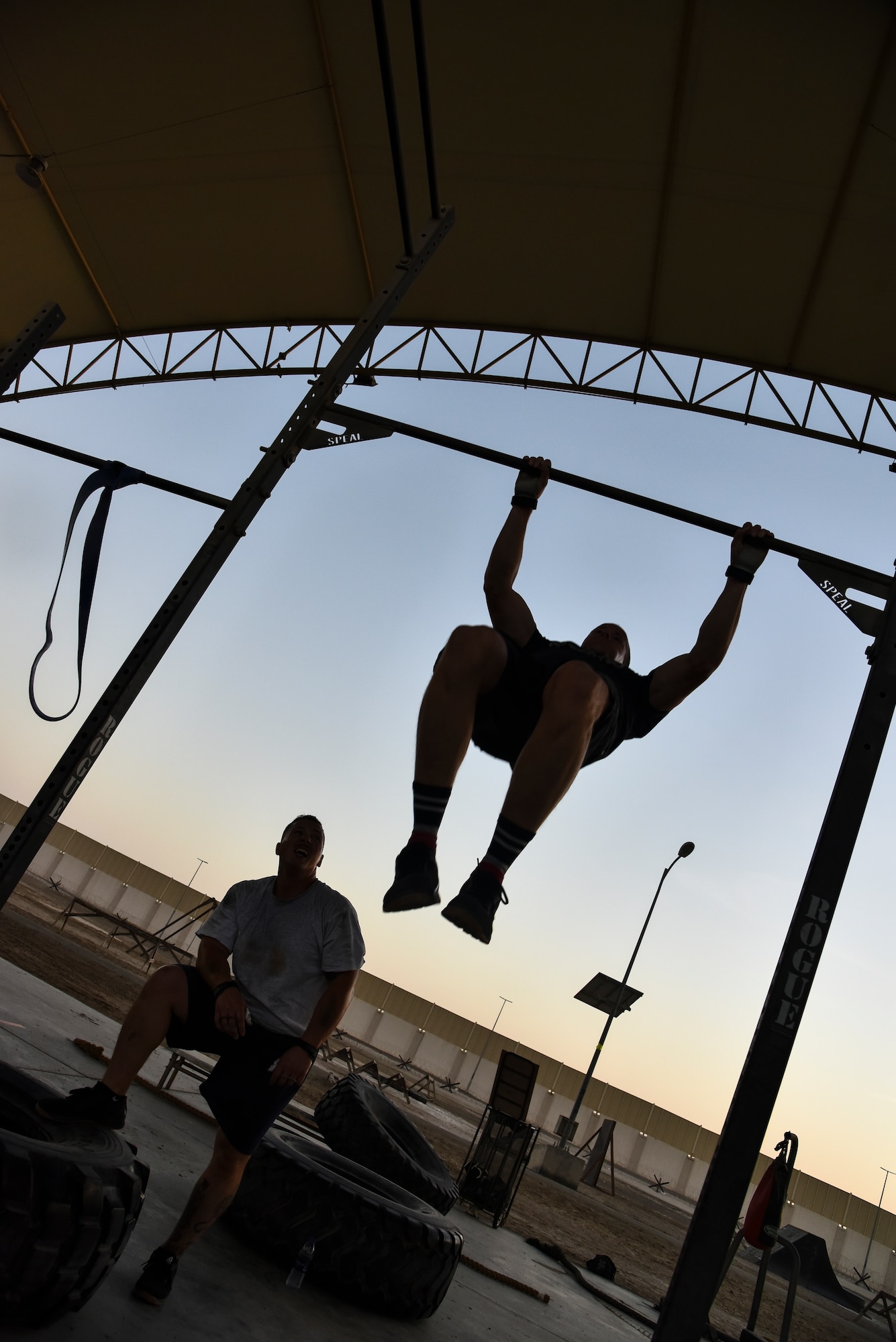 A U.S. Air Force Airman executes chest-to-bar pull-ups during the EOD 134 Memorial Workout at Al Dhafra Air Base, United Arab Emirates, Nov. 30, 2018. 380th Air Expeditionary Wing Airmen, along with coalition partners, participated in the workout to honor the 134 EOD technicians from the U.S. Air Force, Army, Navy and Marine Corps that have been killed since Sept. 11, 2001. (U.S. Air Force photo by Senior Airman Mya M. Crosby)