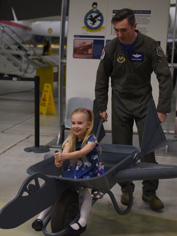 A guest of the 492nd Fighter Squadron Children’s Christmas Party rides in an aircraft wheelbarrow at the Duxford Imperial War Museum, Cambridge, England, Dec. 1, 2018. Around 50 members and spouses from the 492nd FS ‘Madhatters’ collaborated with the three charity organizations to help bring some extra joy this holiday season to children with serious or terminal illness or severe burns. (U.S. Air Force photo by Staff Sgt. Alex Fox Echols III)
