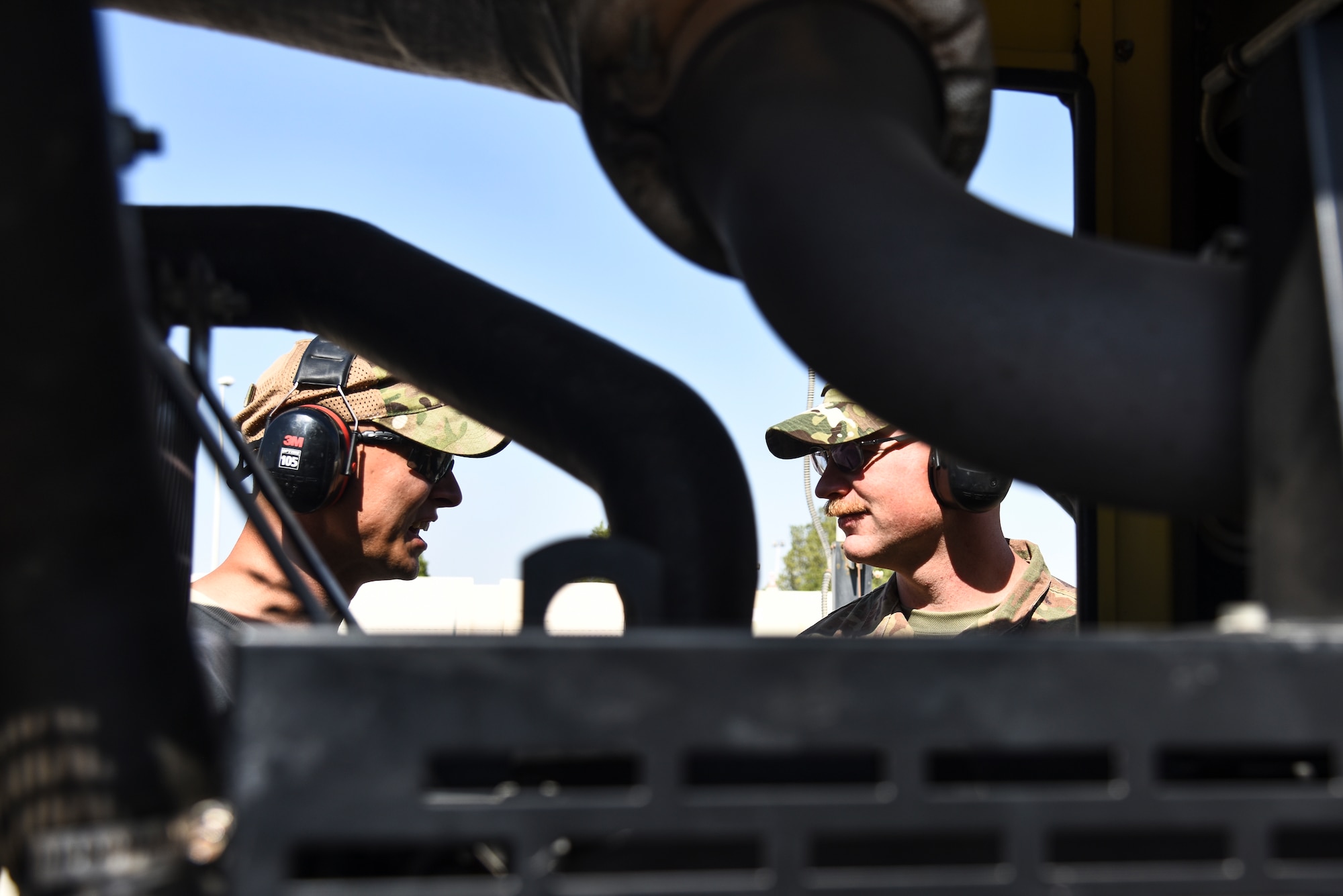 U.S. Air Force Staff Sgts. Shaun Kelly and Tyler Muldowney, 380th Expeditionary Civil Engineer Squadron electrical power production craftsmen, provide maintenance on a backup emergency generator. The Power Production flight provides two main capabilities: maintaining power generators for buildings across the installation, and ensuring the integrity of the fighter aircraft arresting barrier systems on the flight line. (U.S. Air Force photo by Senior Airman Mya M. Crosby)