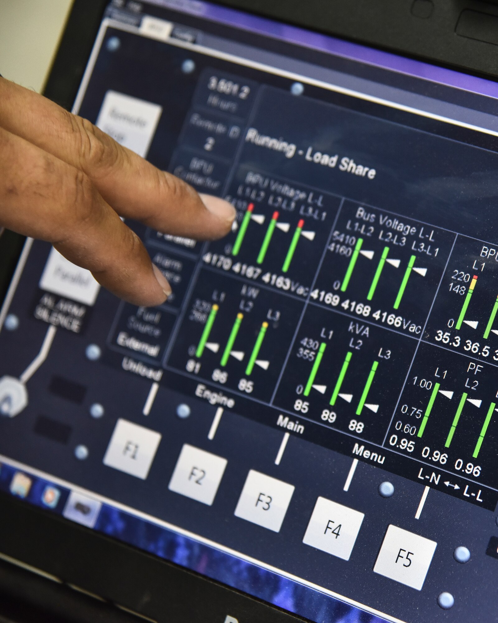 U.S. Air Force Staff Sgt. Tyler Muldowney, 380th Expeditionary Civil Engineer Squadron electrical power production craftsman, controls a remote Operator Panel for a BPU system at Al Dhafra Air Base, United Arab Emirates, Nov. 19, 2018. The Power Production flight provides two main capabilities: maintaining power generators for buildings across the installation, and ensuring the integrity of the fighter aircraft arresting barrier systems on the flight line. (U.S. Air Force photo by Senior Airman Mya M. Crosby)