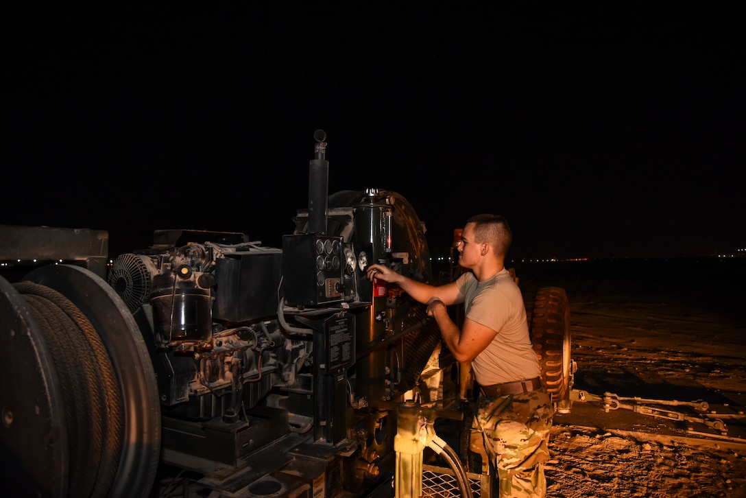 U.S. Air Force Senior Airman Jacob Cornelius, 380th Expeditionary Civil Engineer Squadron electrical power production and barrier maintenance journeyman, provides daily maintenance on a BAK-12 Aircraft Arresting System at Al Dhafra Air Base, United Arab Emirates, Nov. 24, 2018. The Power Production barrier maintenance shop’s job centers on a 195-foot-long cable that assists in the case of a fighter jet in need of an emergency landing at ADAB. (U.S. Air Force photo by Senior Airman Mya M. Crosby)