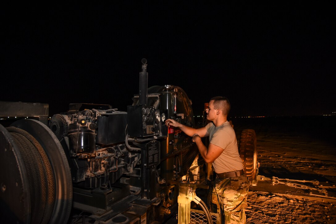 U.S. Air Force Senior Airman Jacob Cornelius, 380th Expeditionary Civil Engineer Squadron electrical power production and barrier maintenance journeyman, provides daily maintenance on a BAK-12 Aircraft Arresting System at Al Dhafra Air Base, United Arab Emirates, Nov. 24, 2018. The Power Production barrier maintenance shop’s job centers on a 195-foot-long cable that assists in the case of a fighter jet in need of an emergency landing at ADAB. (U.S. Air Force photo by Senior Airman Mya M. Crosby)