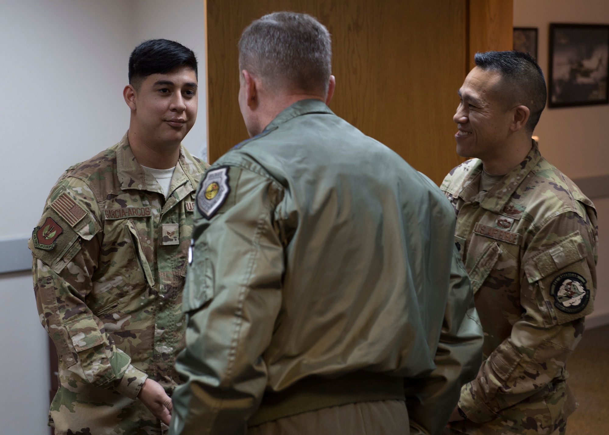 U.S. Air Force Senior Airman George Garcia-Arcos receives a coin from U.S. Air Force Gen. Tod D. Wolters.
