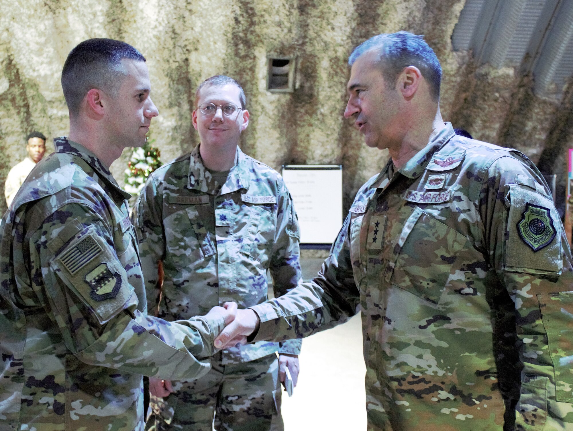 Lt. Gen. Joseph T. Guastella, U.S. Air Forces Central Command commander, shakes hands with 332d Air Expeditionary Wing financial management budget analyst Tech. Sgt. Jonathan Grote Dec. 4, 2018.  During his visit, Guastella recognized Airmen for exceptional service in support of U.S. Air Forces Central Command operations.  Grote is deployed from the 132d Wing, Iowa Air National Guard. (U.S. Air Force photo by Maj. John T. Stamm)