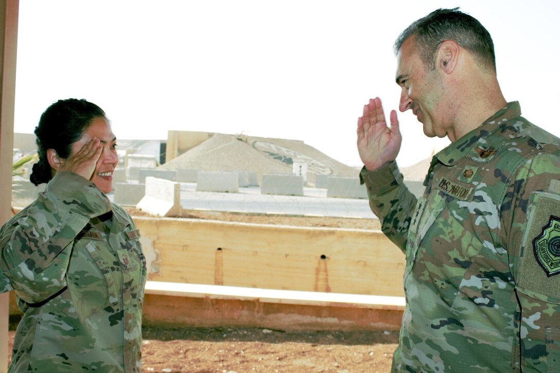 Master Sgt. Maannabelle Maligaya, 332d Expeditionary Maintenance Group Maintenance Operations Flight superintendent, salutes Lt. Gen. Joseph T. Guastella, U.S. Air Forces Central Command commander, Dec. 4, 2018.  During his visit, Guastella recognized Airmen for exceptional service in support of U.S. Air Force Central Command operations.  Maligaya is from Beale Air Force Base, Calif. (U.S. Air Force photo by Maj. John T. Stamm)