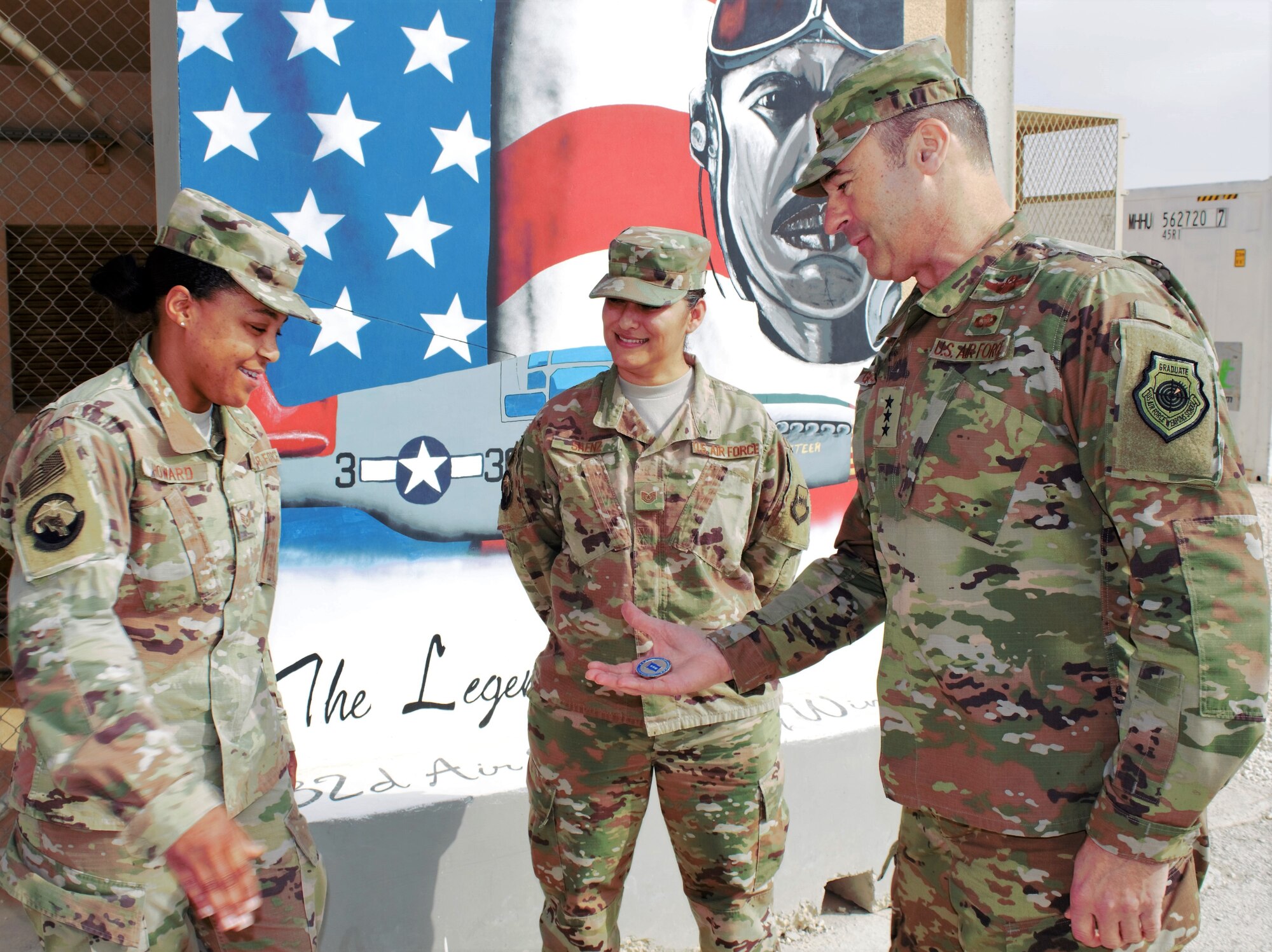 Lt. Gen. Joseph T. Guastella, U.S. Air Forces Central Command commander, presents a challenge coin to Tech. Sgt. Antinita Howard, 332d Expeditionary Force Support Squadron storeroom non-commissioned officer in charge, Dec. 4, 2018.  During his visit, Guastella recognized several Airmen for exceptional service in support of U.S. Air Force Central Command operations.  Commanders often present challenge coins in recognition of special achievements.  Howard is from Beale Air Force Base, Calif.  (U.S. Air Force photo by Maj. John T. Stamm)