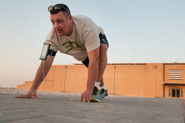 Chaplain (Maj.) Jack Miller, 379th Air Expeditionary Wing chaplain, stretches prior to a workout Dec. 6, 2018, at Al Udeid Air Base, Qatar. Miller was diagnosed with adrenal cancer in 2012 and told by doctors that he would never run longer distances again. While deployed at Al Udeid, Miller trained for months and was able to complete the base’s Veterans Day 5K run Nov. 11, 2018. (U.S. Air Force photo by Tech. Sgt. Christopher Hubenthal)