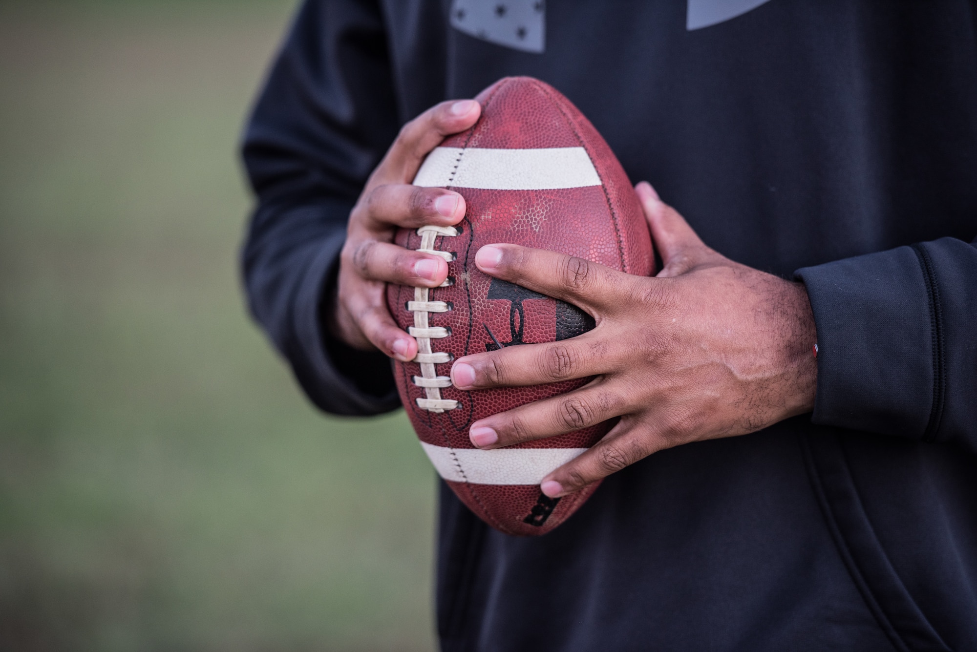 Chief Master Sgt. Anthony Harris, 512 Airlift Wing Force Support Squadron superintendent, holds a football in Dover Delaware, Oct. 18, 2018. Harris played football from a young child until his first year of college. (U.S. Air Force photo by Staff Sgt. Damien Taylor)