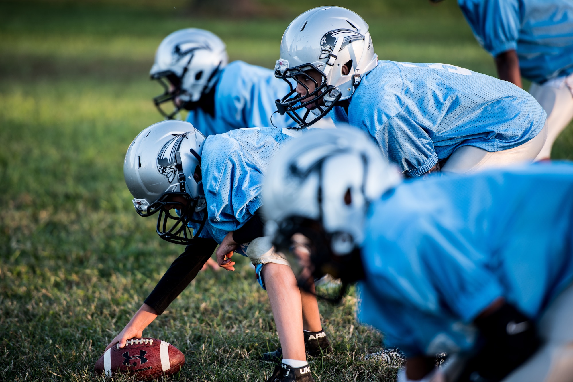 The Pop Warner Dover Caesar Rodney Raiders prepare to run a football play in Dover, Delaware, Oct. 18, 2018. The CR Raiders held practice every Thursday evening from 5:30 to 8 p.m. to prep Saturday games. (U.S. Air Force photo by Staff Sgt. Damien Taylor)