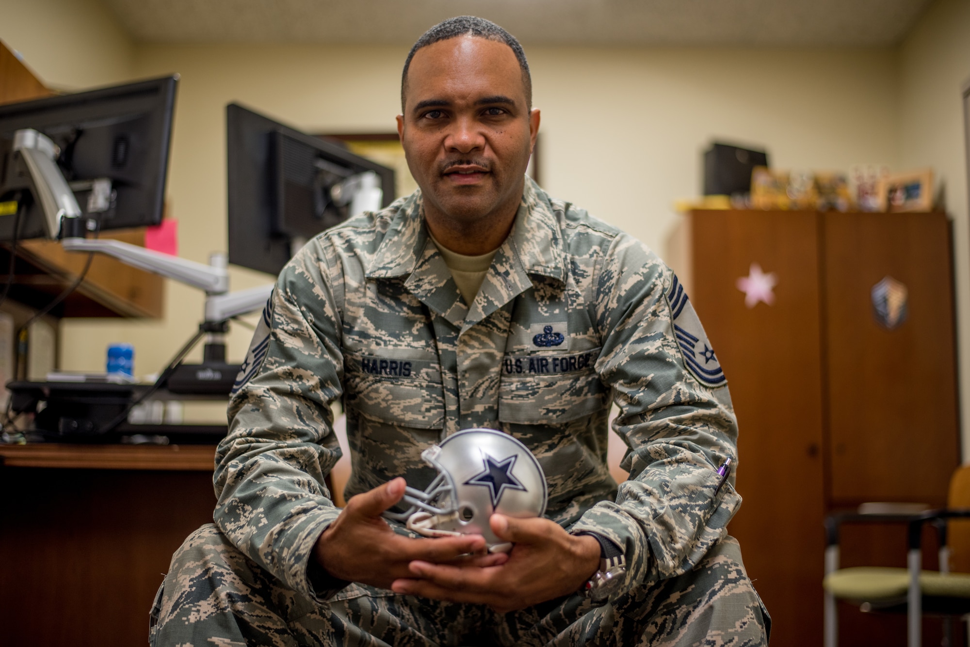 Chief Master Sgt. Anthony Harris, 512 Airlift Wing Force Support Squadron superintendent, poses for a photo in his office at Dover Air Force Base, Delaware, Nov. 24, 2018. Harris played football until his first year of college, learning disciple and resilience that helps him execute the wing mission as a chief master sergeant. (U.S. Air Force photo by Staff Sgt. Damien Taylor)