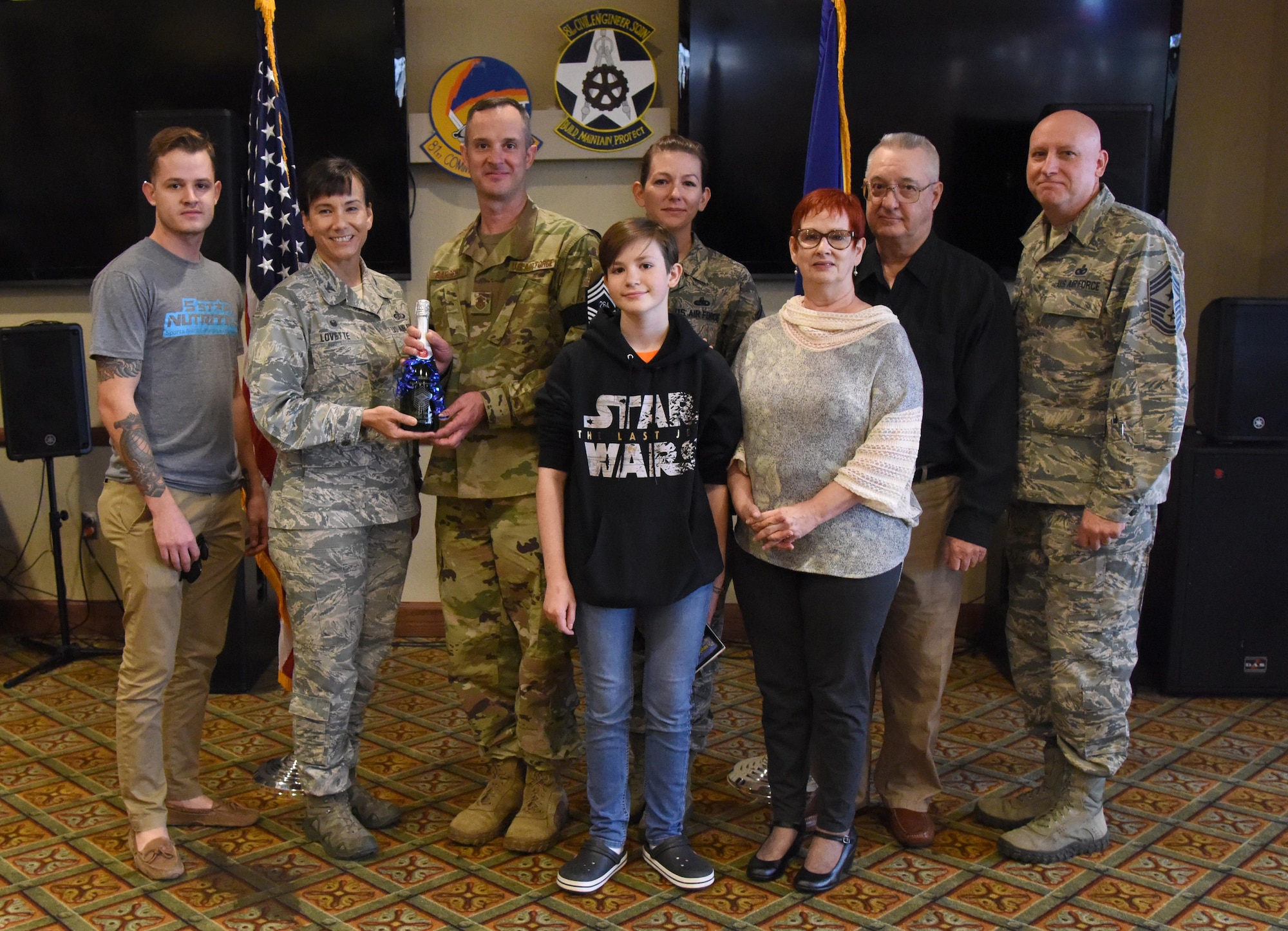 U.S. Air Force Col. Debra Lovette, 81st Training Wing commander, and Chief Master Sgt. David Pizzuto, 81st TRW command chief, presents Senior Master Sgt. Charles Sargent, 338th Training Squadron flight chief, and his family with a memento for his promotion to the rank of chief master sergeant at Keesler Air Force Base, Mississippi, Dec. 6, 2018. Five senior master sgts. at Keesler were selected for promotion. (U.S. Air Force photo by Kemberly Groue)