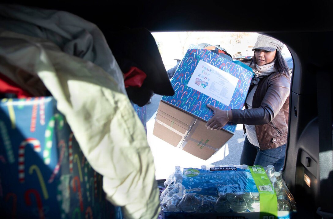Master Sgt. Lan Archilla, 349th Civil Engineer Squadron first sergeant, transports 125 donated children's coats to the Coats for Kids drive at Travis Air Force Base, Calif., Dec. 6, 2018.