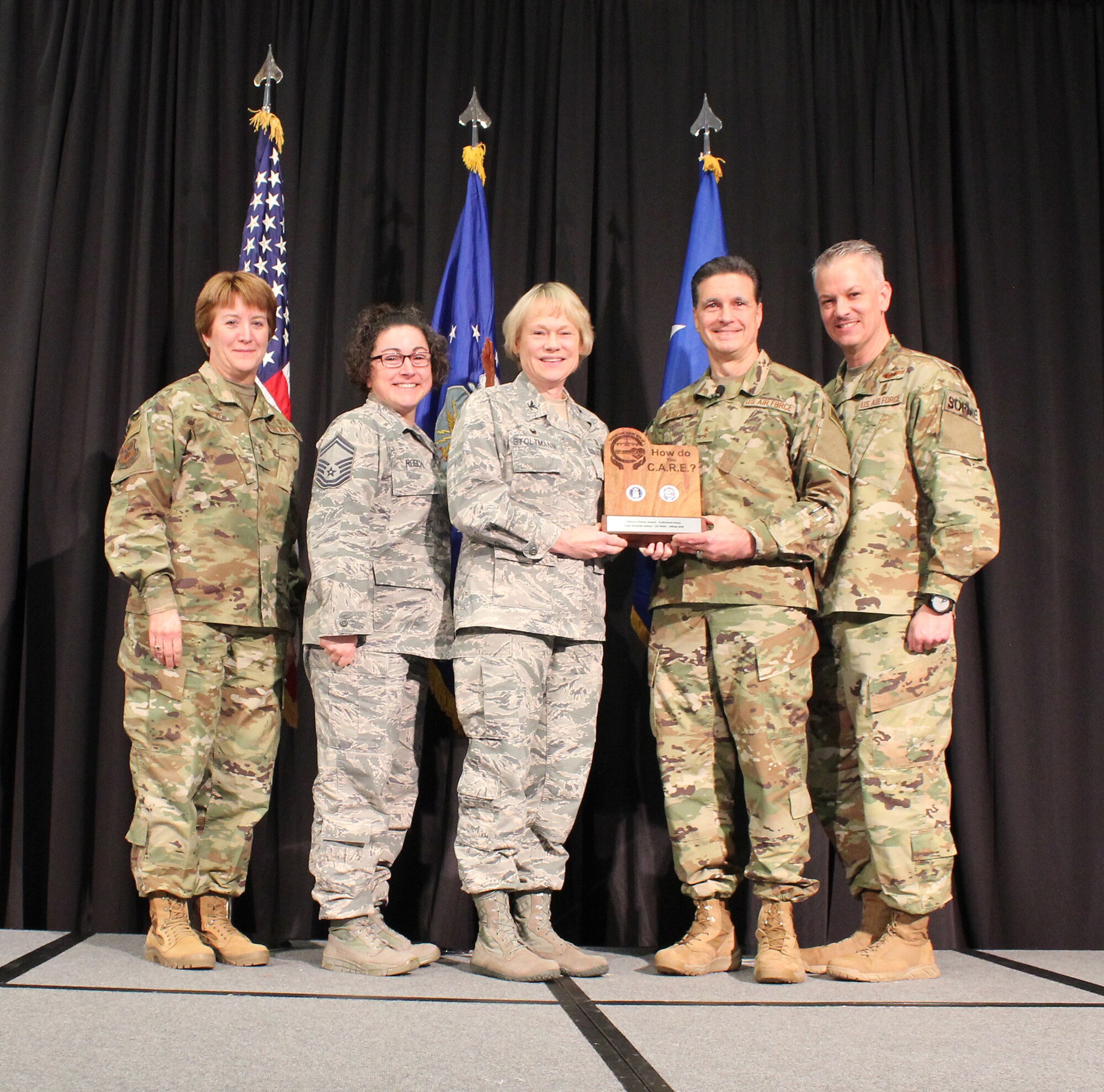 U.S Air Force Lt. Gen. Dorothy Hogg, Air Force Surgeon General, U.S. Air Force Maj. Gen. (Dr.) Sean L. Murphy, Deputy Surgeon General, and Chief Master Sgt. G. Steve Cum, Chief, Medical Enlisted Force and Enlisted Corps Chief, pose with U.S. Air Force Col. Judy Stoltmann and Senior Master Sgt. Holly Roschel, Offutt Air Force Base, Nebraska, during the 2018 Air Force Medical Service Senior Leadership Workshop at the National Conference Center in Leesburg, Va., Dec. 5, 2018. Stoltmann and Roschel accepted the Editor’s Choice Award (Individual Essay) for the Trusted Care “How Do You C.A.R.E.” campaign on behalf of U.S. Air Force Capt. Amanda Atitya. (U.S. Air Force photo by Josh Mahler)