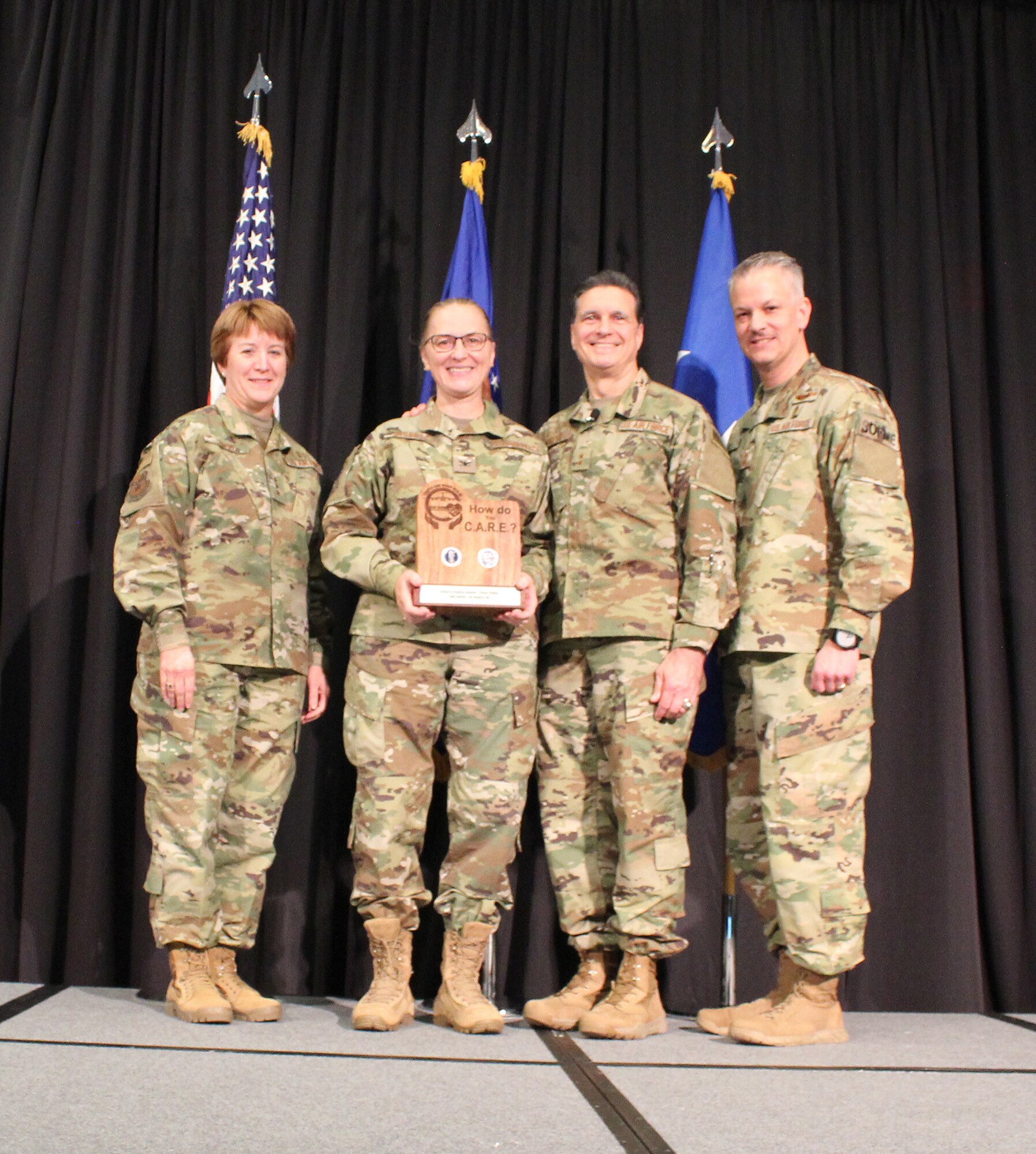 U.S Air Force Lt. Gen. Dorothy Hogg, Air Force Surgeon General, U.S. Air Force Maj. Gen. (Dr.) Sean L. Murphy, Deputy Surgeon General, and Chief Master Sgt. G. Steve Cum, Chief, Medical Enlisted Force and Enlisted Corps Chief, pose with U.S. Air Force Col. Theresa Bisnett, Surgeon General, U.S. Air Forces Central Command, during the 2018 Air Force Medical Service Senior Leadership Workshop at the National Conference Center in Leesburg, Va., Dec. 5, 2018. Bisnett accepted the Editor’s Choice Award (Team Video) and Best Dream Team Award for the Trusted Care “How Do You C.A.R.E.” campaign on behalf of TSgt. Ines McIntyre and Capt. Pedro Avila-Morales and Al Dhafra AB. (U.S. Air Force photo by Josh Mahler)