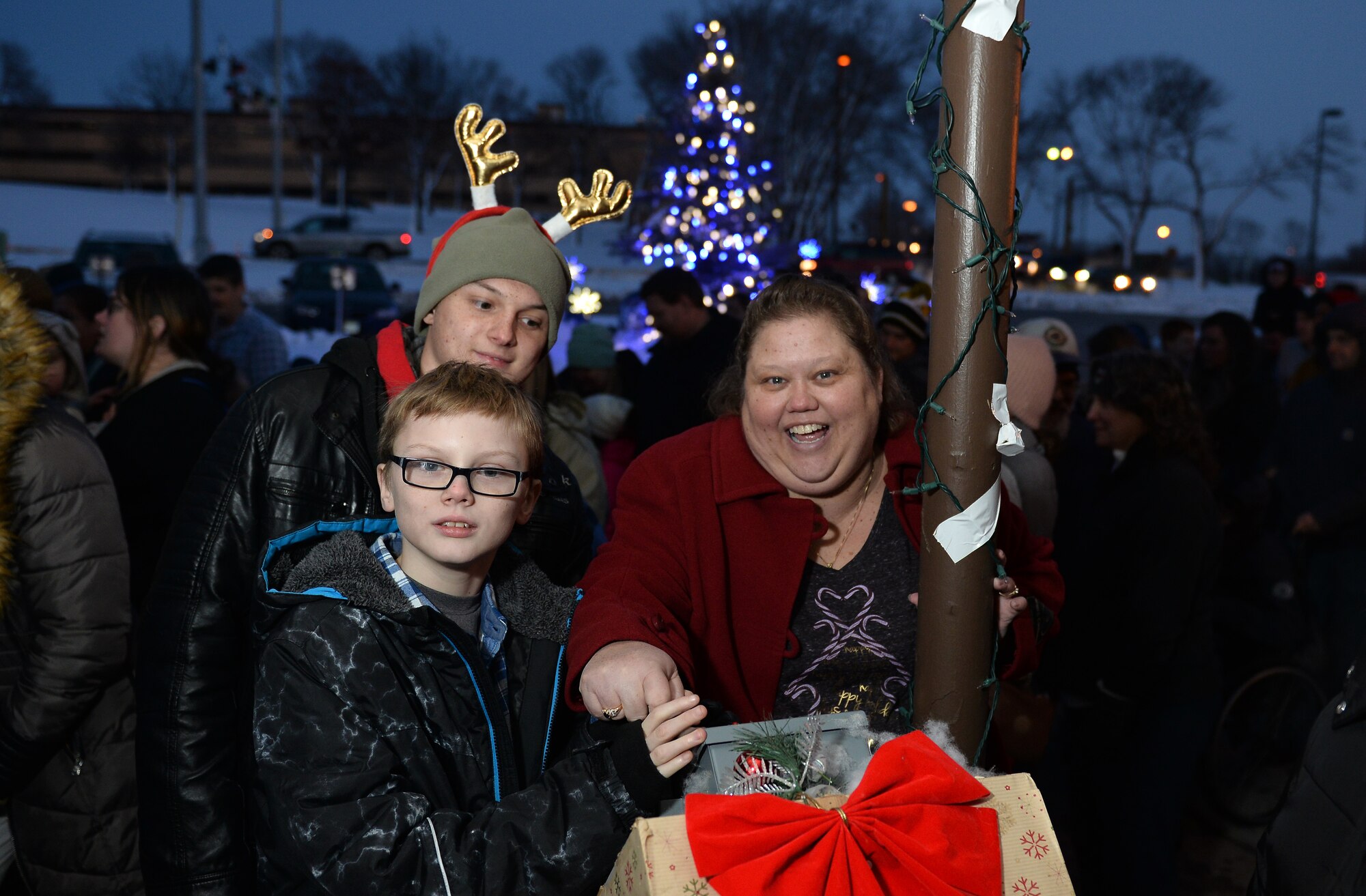 The Clark family lights the Christmas tree during the annual Offutt Christmas Tree Lighting event held at the Patriot Club, Offutt Air Force Base, Nebraska, Dec. 6, 2018. Following the tree lighting, the crowd of attendees made their way into the club for the evening’s festivities. (U.S. Air Force photo by Josh Plueger)