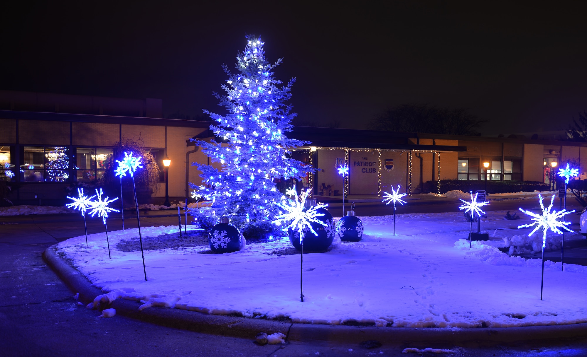 A tree used for the annual Offutt Christmas Tree Lighting ceremony, stands lit outside the Patriot Club on Offutt Air Force Base, Nebraska, Dec. 6, 2018. The 55th Force Support Squadron’s tree lighting event was attended by an estimated 1,500 active-duty members and dependents. (U.S. Air Force photo by Josh Plueger)