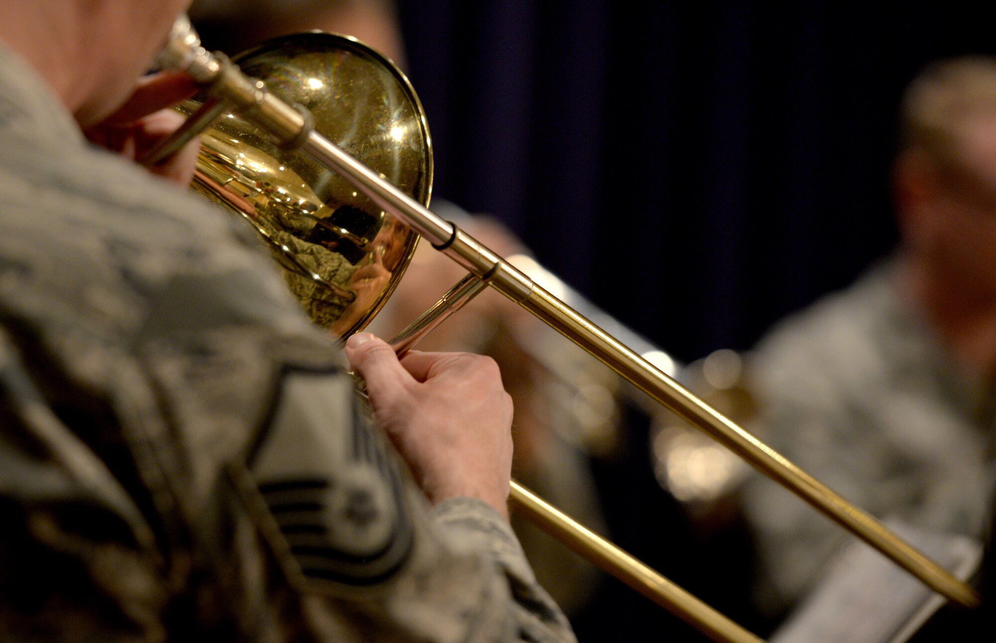 Master Sgt. Benjamin Kadow, U.S. Air Force Heartland of America Band trombone player, plays at trumpet during the Offutt Christmas Tree Lighting event at the Patriot Club, Offutt Air Force Base, Nebraska, Dec. 6, 2018. The band’s brass ensemble played multiple sets throughout the night while an estimated 1,500 base members moved throughout the club participating in numerous events. (U.S. Air Force photo by Josh Plueger)