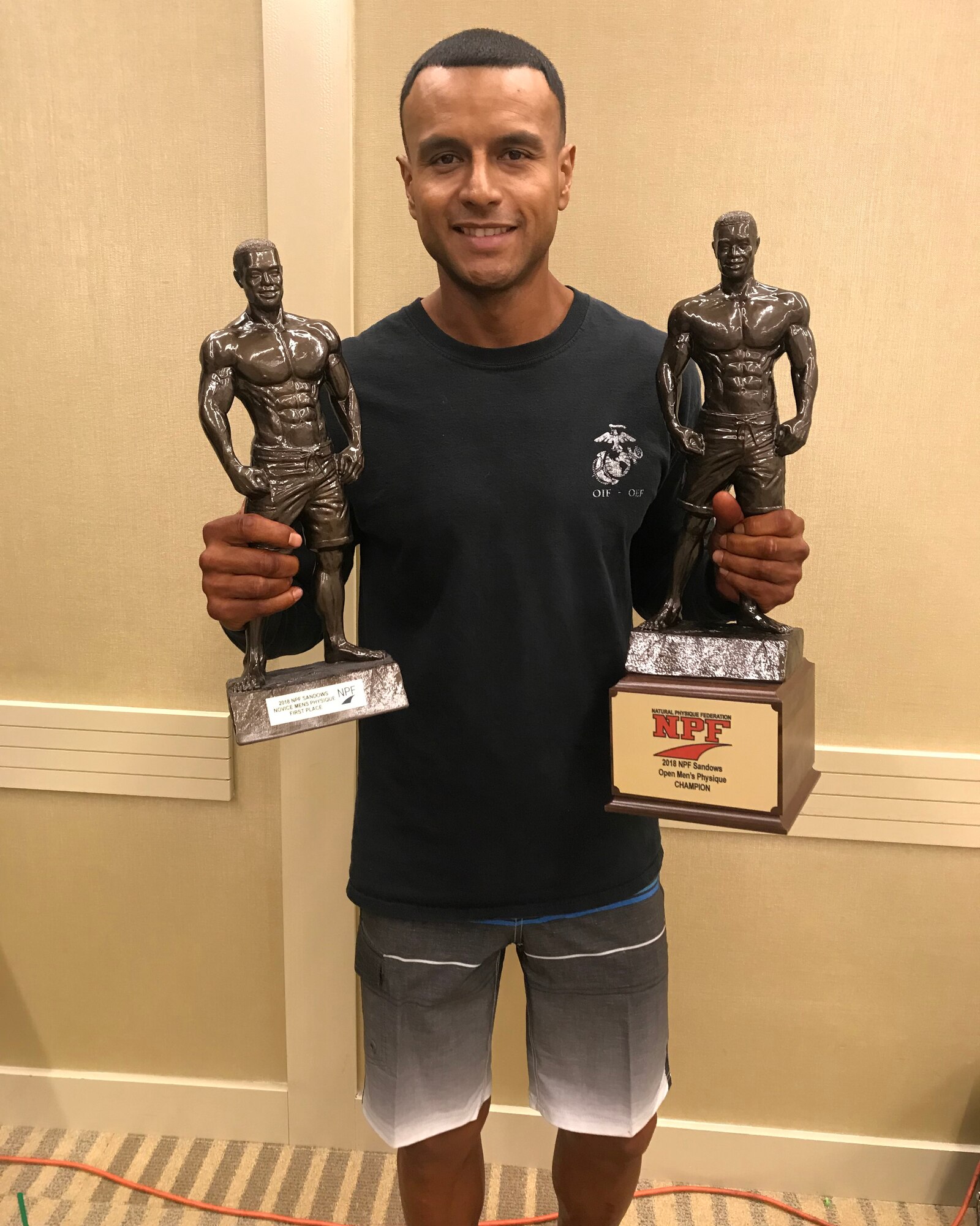 Master Sgt. Jonathan Nossa, an Airman assigned to the 178th Wing, poses with his first place trophies Nov. 17 at the Greater Columbus Convention Center in Columbus, Ohio. Nossa competed in the 2018 NPF Sandows Natural World Championship and won first place in novice men’s physique and open men’s physique.