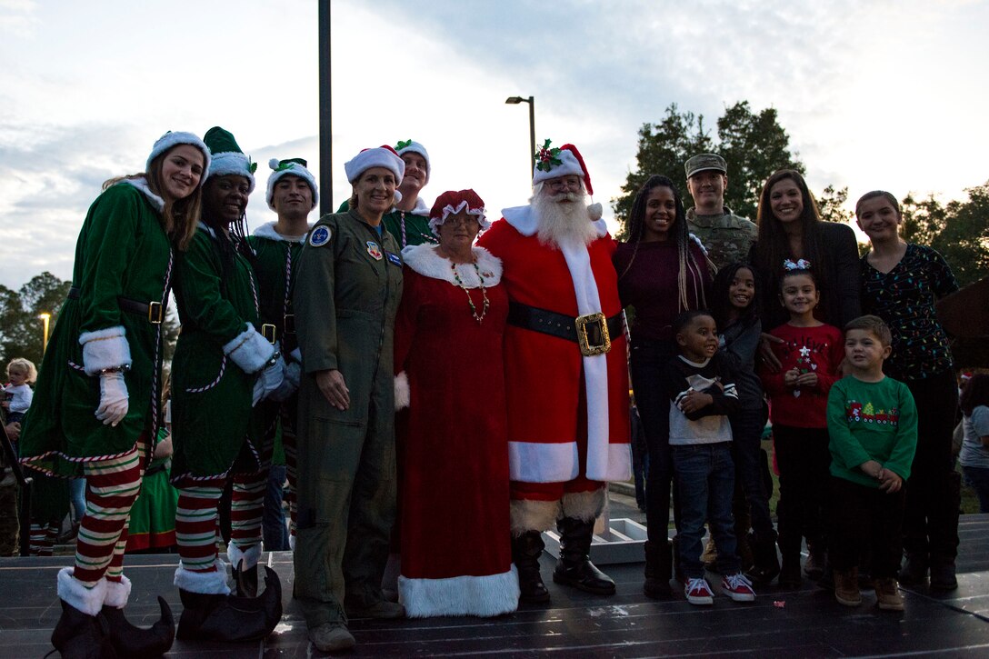 Members of Team Moody pose with Santa and Mrs. Claus for a photo during the Tree Lighting Ceremony, Nov. 30, 2018, at Moody Air Force Base, Ga. The event continues the tradition of families of deployed Airmen lighting the base Christmas tree. As a way to celebrate the sacrifices of Team Moody Airmen and their families, the base also hosted a parade and other holiday festivities. (U.S. Air Force photo by Airman 1st Class Erick Requadt)