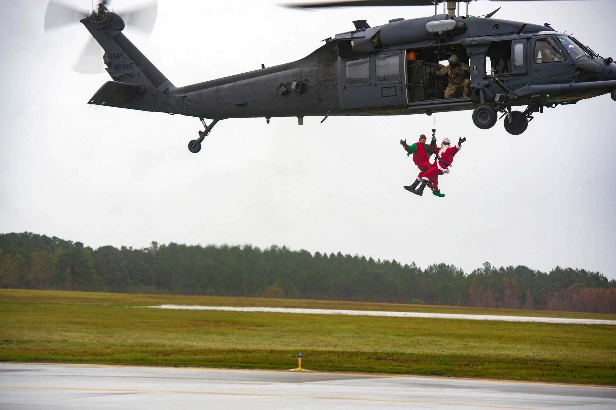 Santa and his elf rappel from an HH-60G Pave Hawk during the 347th Rescue Group and 23d Maintenance Group Children’s Christmas Party, Dec. 1, 2018, at Moody Air Force Base, Ga. Airmen and their families enjoyed the holiday festivities by taking photos with Santa, face painting and playing games. (U.S. Air Force photo by Senior Airman Gregory Nash)