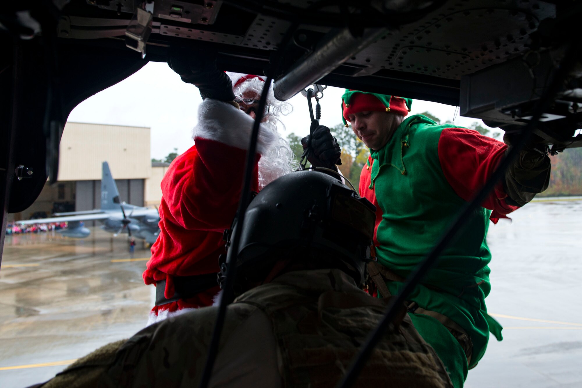 Santa and his elf rappel from an HH-60G Pave Hawk during the 347th Rescue Group and 23d Maintenance Group Children’s Christmas Party, Dec. 1, 2018, at Moody Air Force Base, Ga. Airmen and their families enjoyed the holiday festivities by taking photos with Santa, face painting and playing games. (U.S. Air Force photo by Airman 1st Class Erick Requadt)