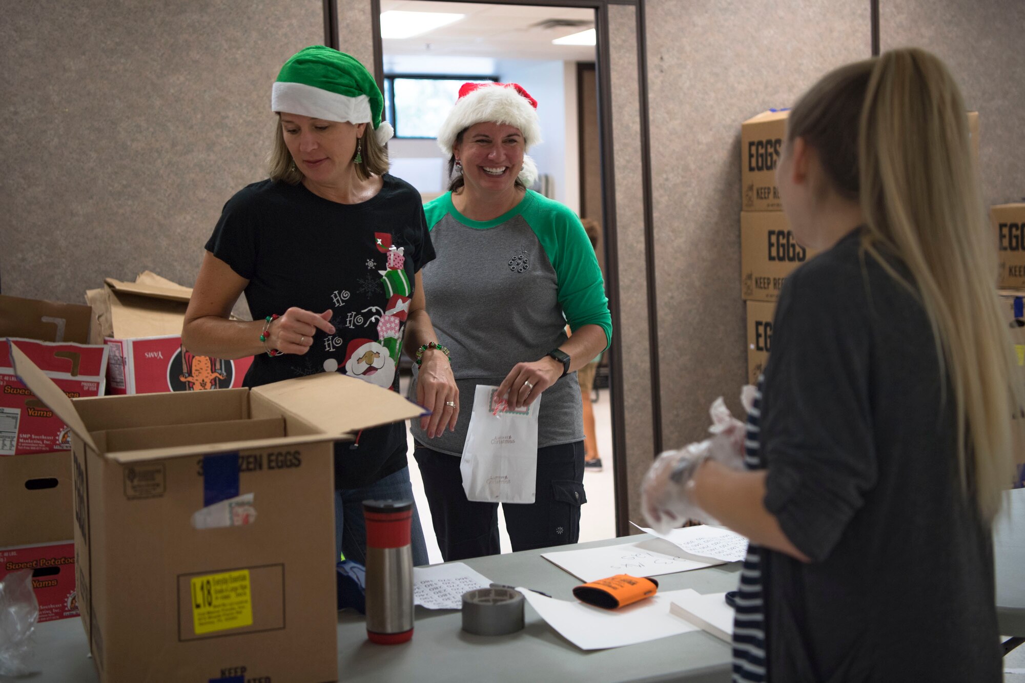 Team Moody spouses socialize during the Annual Moody Airmen Cookie Drive, Dec. 3, 2018, at Moody Air Force Base, Ga. The cookie drive produced over 100 bags of cookies to show appreciation for the Airmen across base during the holidays. (U.S. Air Force photo by Airman Taryn Butler)
