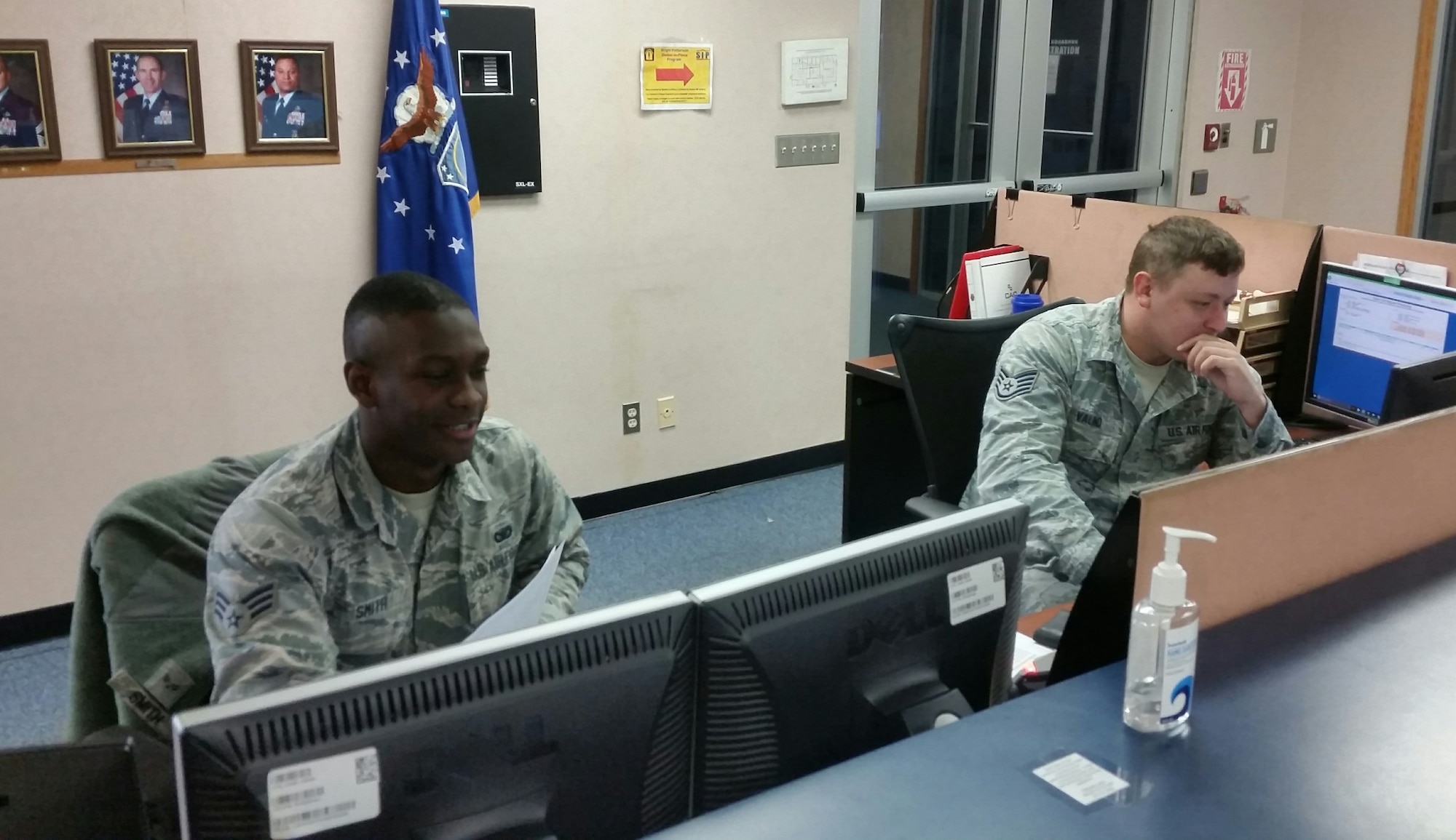 Senior Airman Travion Smith and Staff Sgt. Joshua Valind, Pass and Registration clerks in Building 286, Area A, Input vital information for clearing a customer for access to Wright-Patterson Air Force Base.